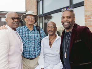 Four men at posing for a picture