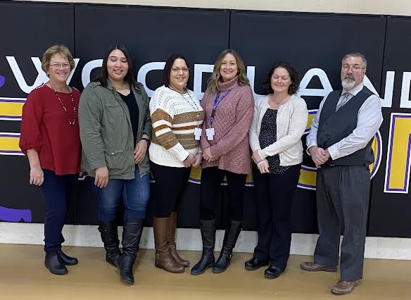 Six people, who are the school's behavioral health team, standing in the gym.