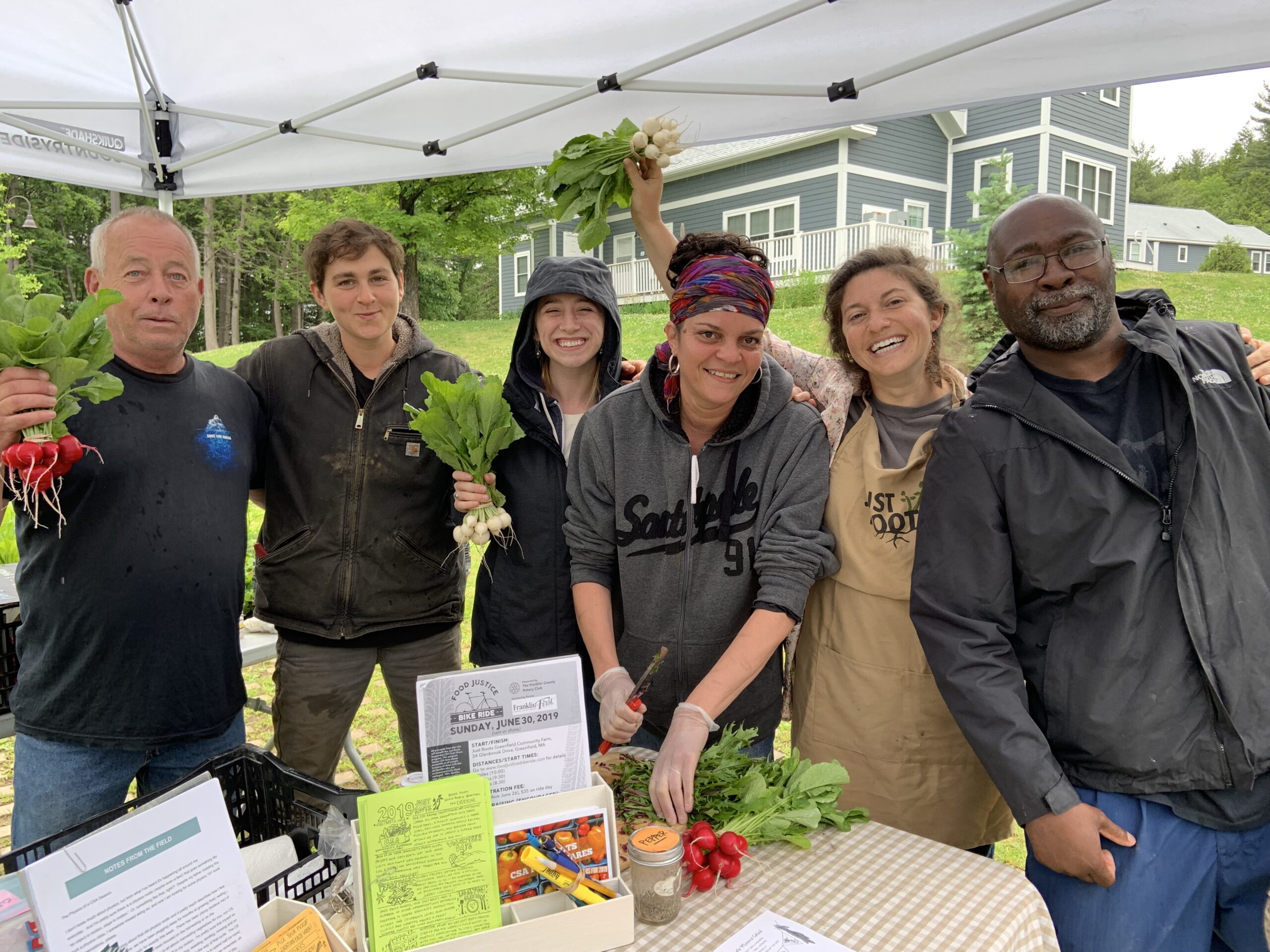 Group of people posing with fresh vegetables